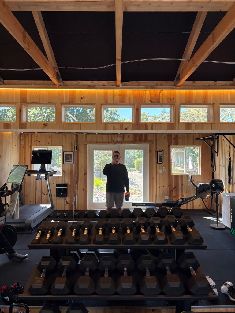 Mirror selfie showing the whole home gym