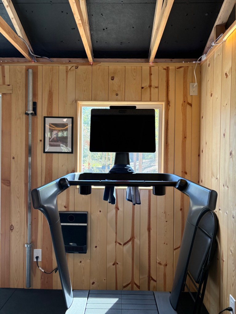 Wide view of our home gym with the treadmill