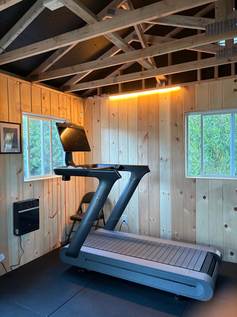 Side profile of the Peloton Tread+ treadmill in the gym