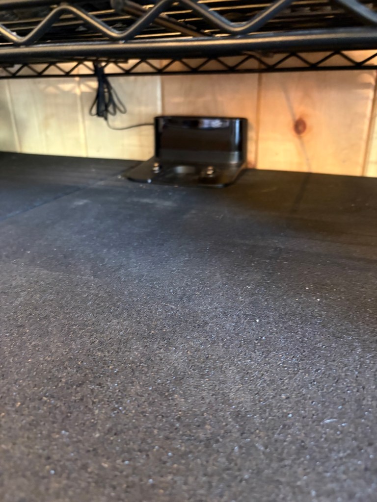 eufy vacuum charging dock tucked under the shelf