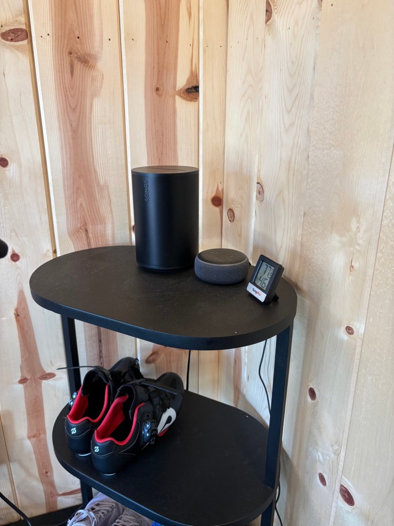 Shelf in the gym with Sonos Era 100 speaker, Amazon Echo Dot, and TempPro gauge