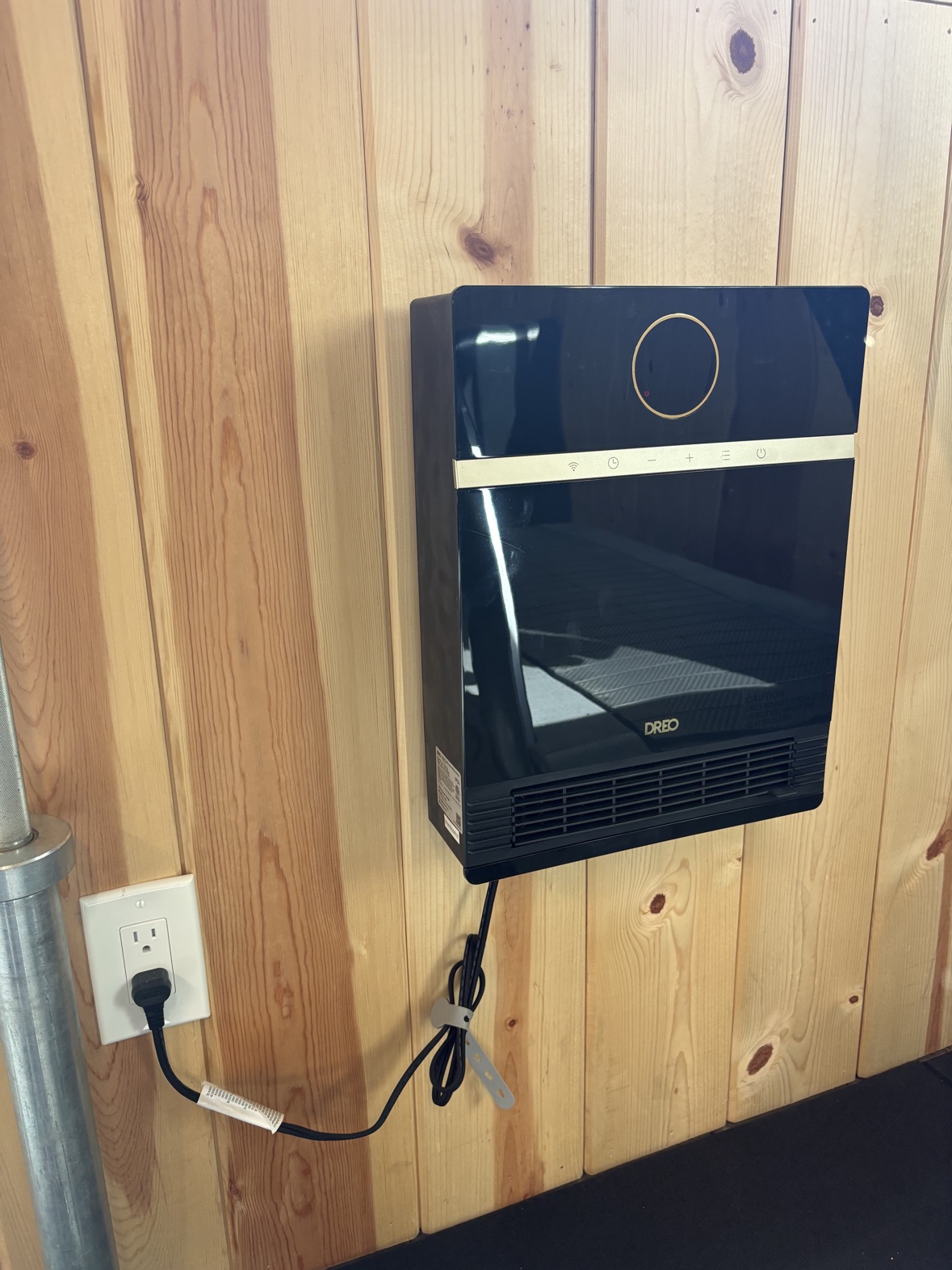 DREO smart wall heater mounted on the wall in our home gym